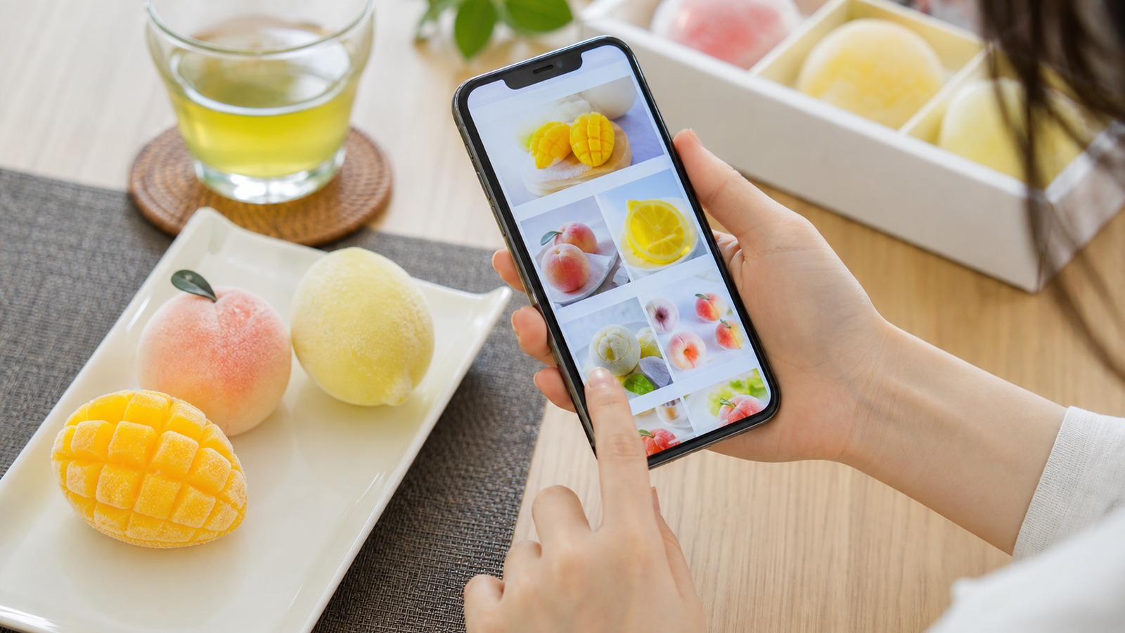 スマートフォンで果物型の輸入アイスを通販検索している手元